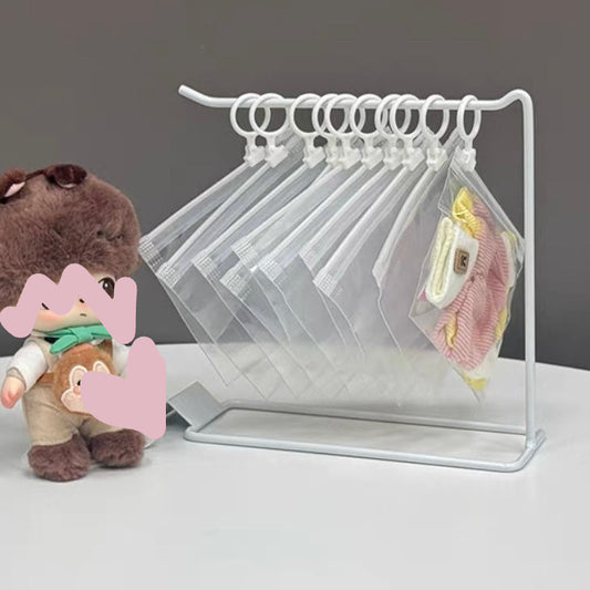 White hanger stand with transparent bags on a gray background