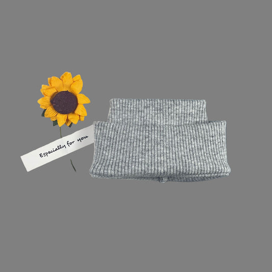 Gray textured hat with a sunflower brooch on a card with text, against a gray background