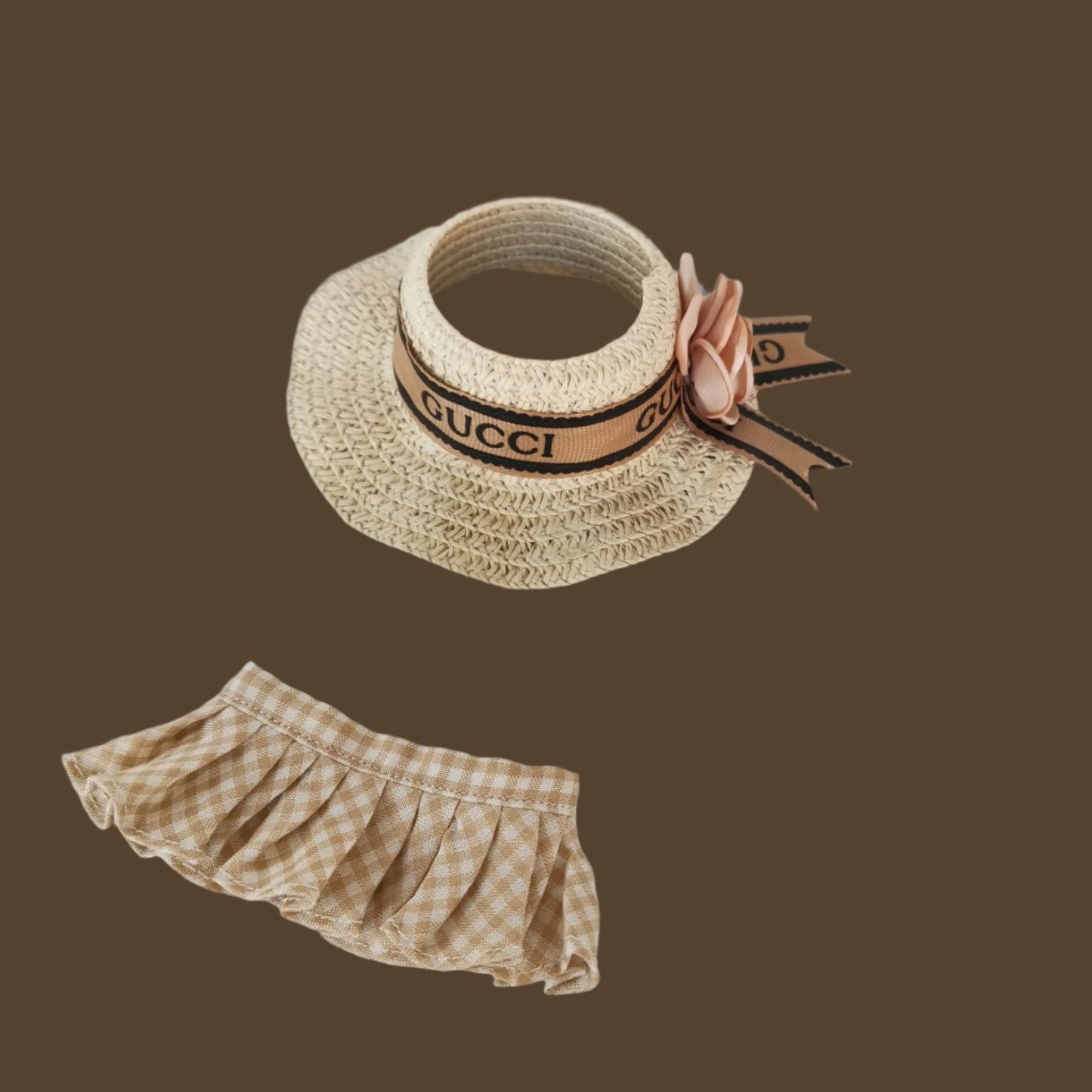 Straw hat with Gucci logo and checkered bloomers on a light gray background